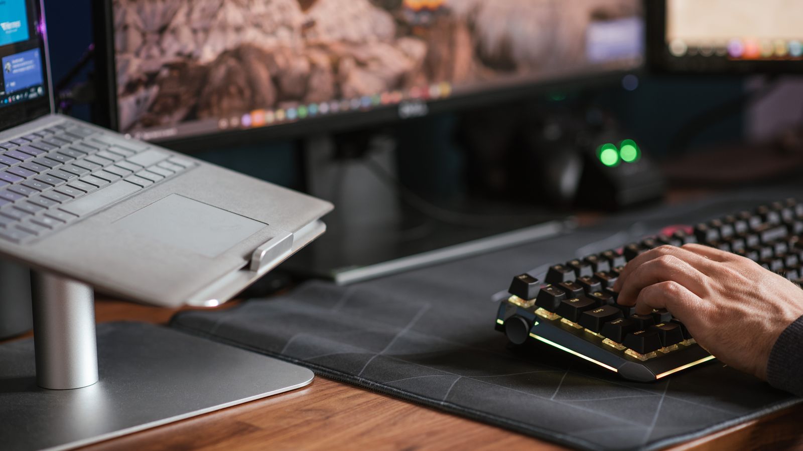 A professional working at a laptop and external keyboard.