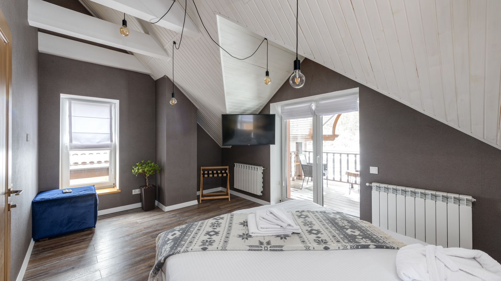 A contemporary bedroom beneath a sloping ceiling.