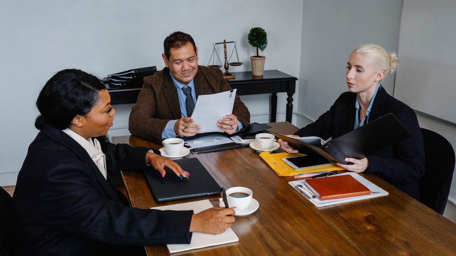 Coworkers discussing a business project around a table.