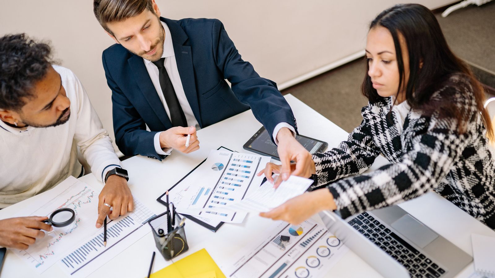 A business team discussing plans and documents.